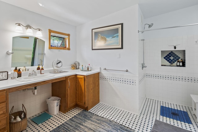 bathroom with vanity, tile walls, and tile floors