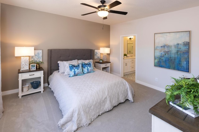 carpeted bedroom with connected bathroom and ceiling fan