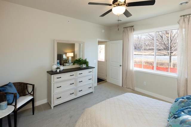 carpeted bedroom featuring multiple windows and ceiling fan