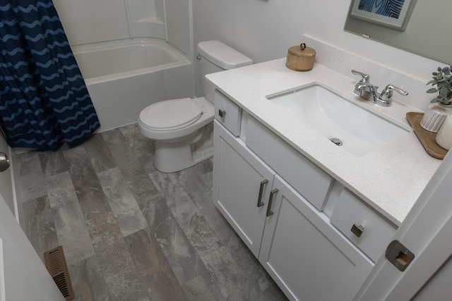 full bathroom featuring shower / tub combo with curtain, vanity, and toilet