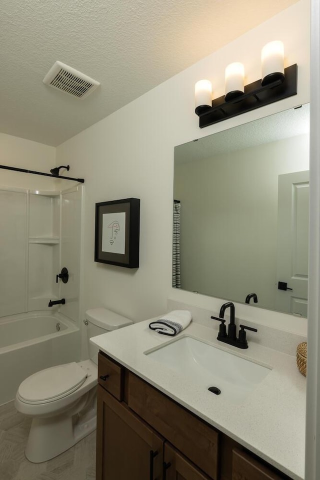 full bathroom with a textured ceiling, bathing tub / shower combination, tile floors, toilet, and oversized vanity