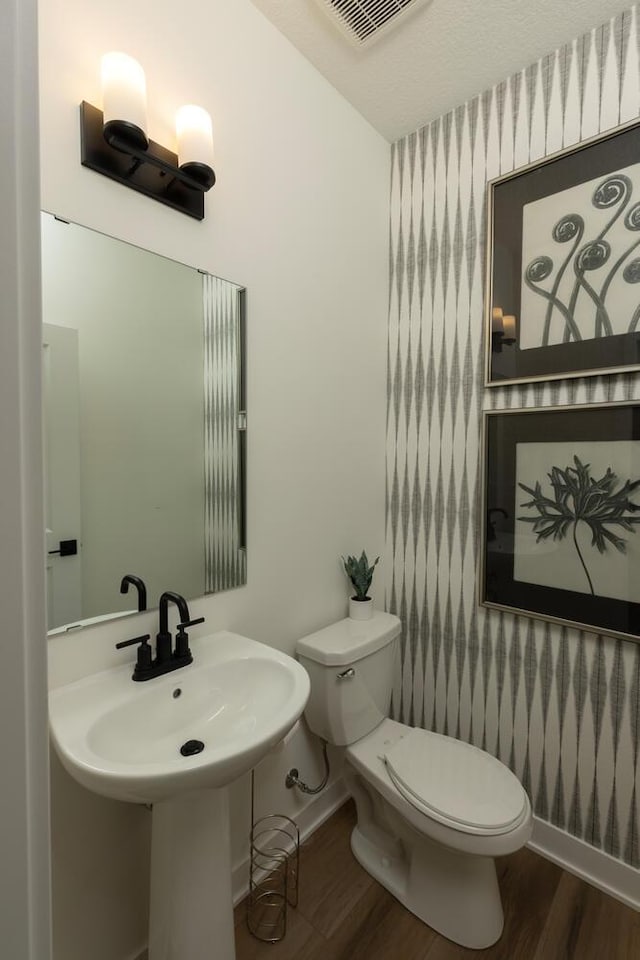 bathroom featuring sink, hardwood / wood-style flooring, and toilet