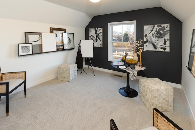 miscellaneous room with lofted ceiling and carpet flooring