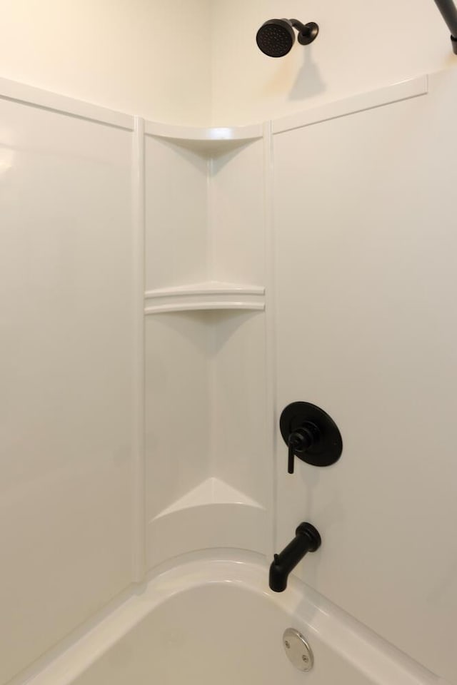 details featuring shower / washtub combination