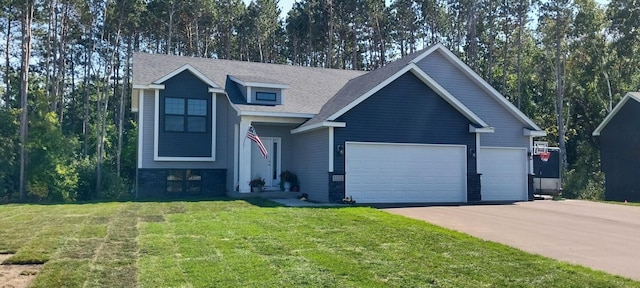 view of front of house featuring a front lawn and a garage