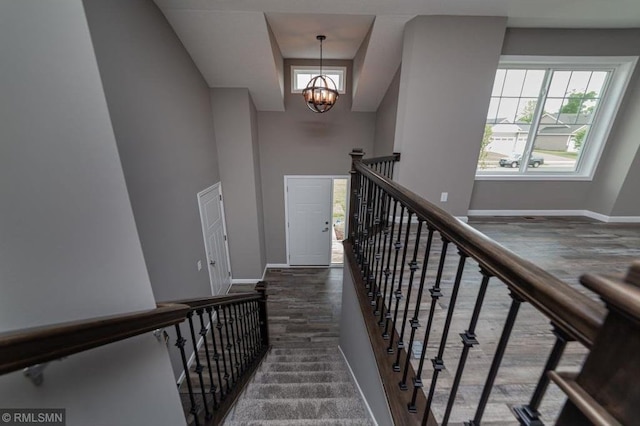 stairs with an inviting chandelier