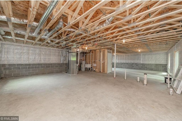 basement featuring heating unit and water heater