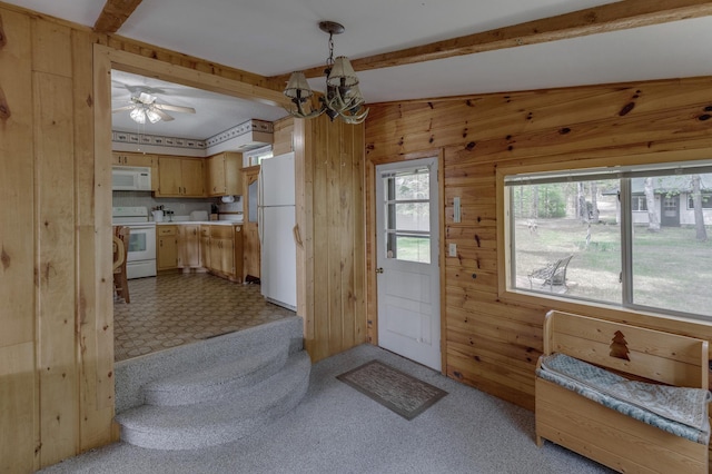 tiled entrance foyer with wood walls, ceiling fan with notable chandelier, and lofted ceiling with beams