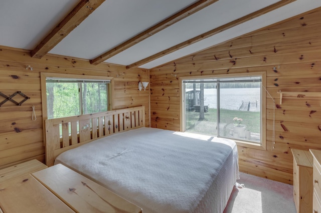 bedroom with wood walls, a water view, light colored carpet, and vaulted ceiling with beams