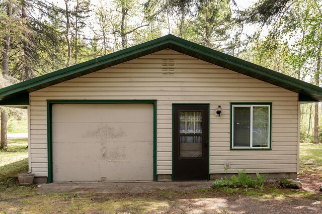 view of front of house featuring a garage and an outdoor structure