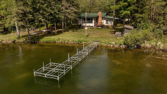 view of dock featuring a water view and a lawn