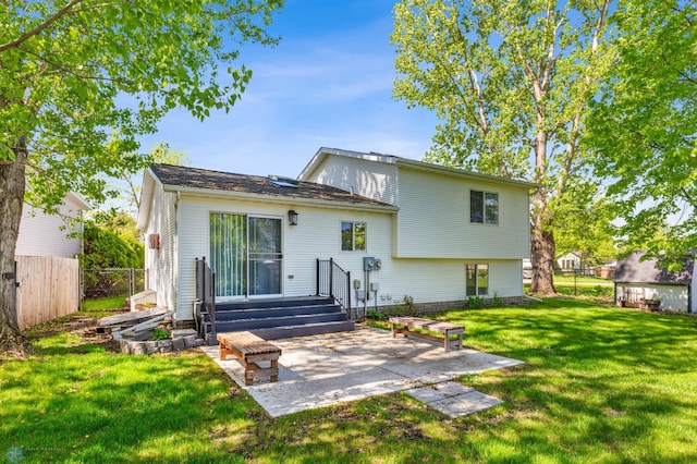 back of house with a lawn and a patio