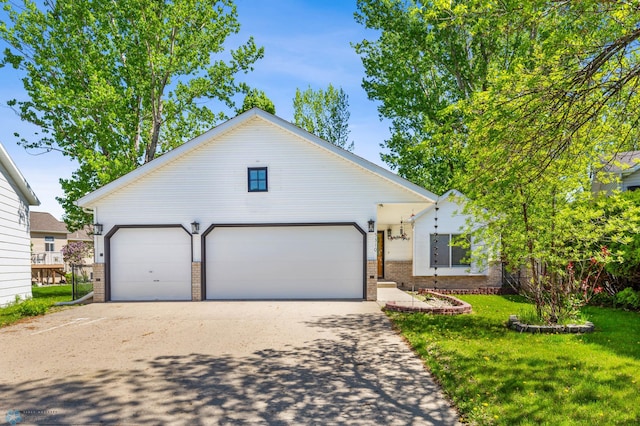 view of front of house with a front yard and a garage