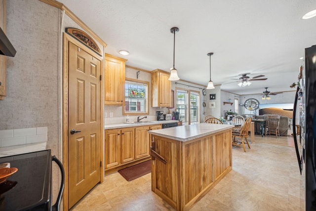 kitchen featuring ornamental molding, a kitchen island, pendant lighting, ceiling fan, and light tile floors