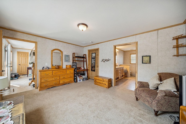 bedroom featuring carpet, ornamental molding, and ensuite bath