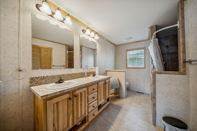 bathroom with tile flooring, ornamental molding, double sink, tasteful backsplash, and oversized vanity