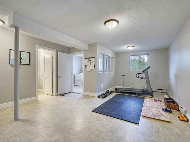 workout room featuring a textured ceiling and washer / clothes dryer