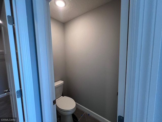 bathroom with tile patterned flooring and toilet