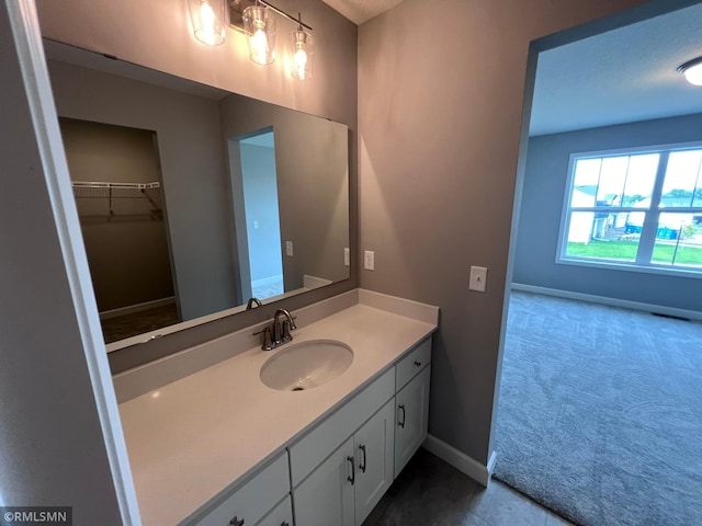 bathroom with a textured ceiling, tile patterned flooring, and vanity