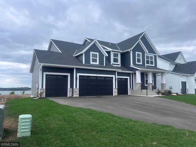 craftsman house with a garage and a front yard