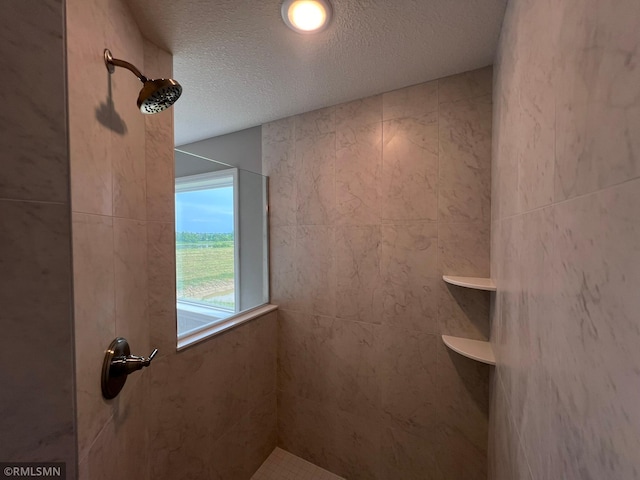 bathroom featuring walk in shower and a textured ceiling