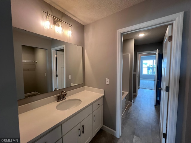 bathroom with vanity, tile patterned flooring, and a textured ceiling