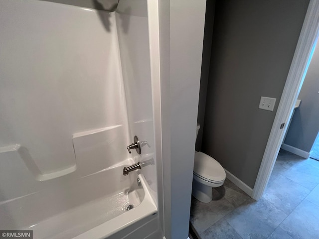 bathroom featuring shower / tub combination and toilet