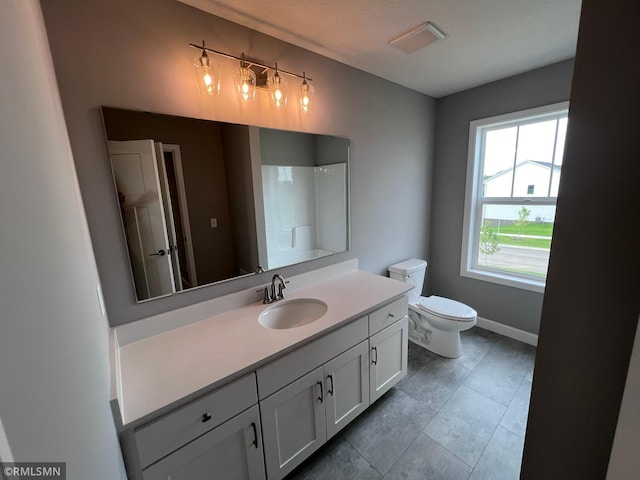 bathroom with tile patterned flooring, vanity, and toilet