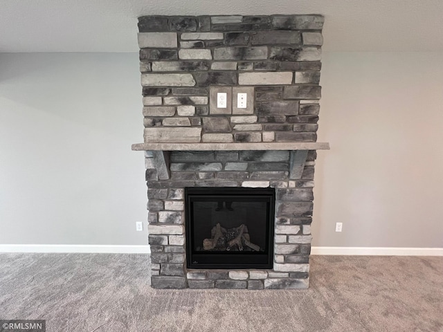 details with a stone fireplace, a textured ceiling, and carpet