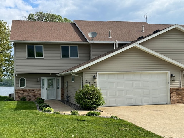 view of front of property featuring a garage and a front lawn