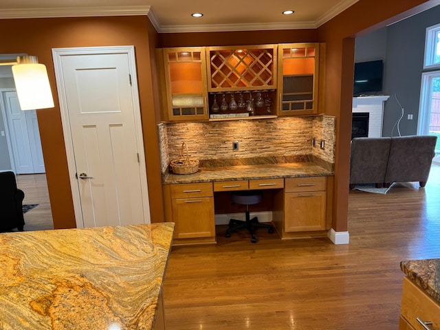 office with ornamental molding and hardwood / wood-style flooring