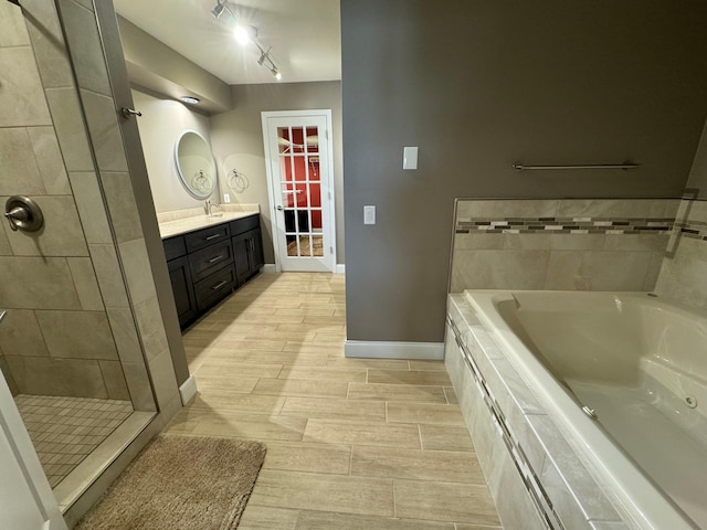 bathroom featuring independent shower and bath and vanity