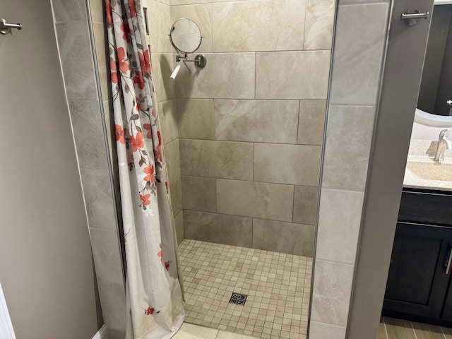 bathroom featuring walk in shower and vanity