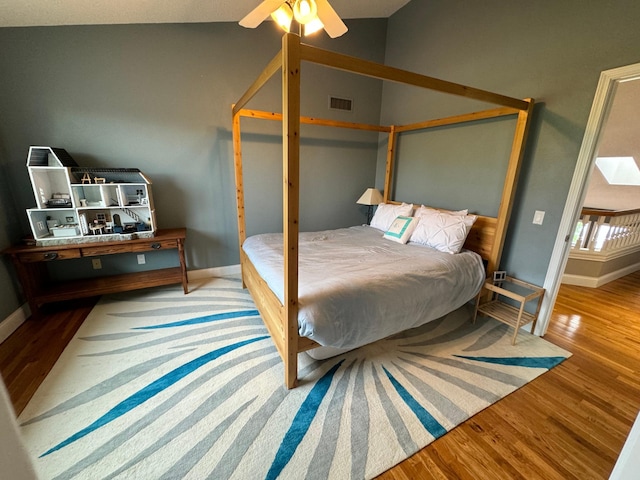 bedroom with lofted ceiling, light wood-type flooring, and ceiling fan