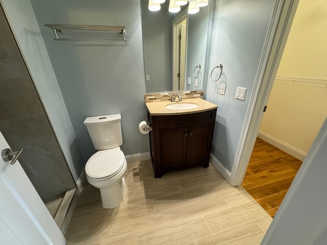 bathroom with vanity, toilet, and hardwood / wood-style floors