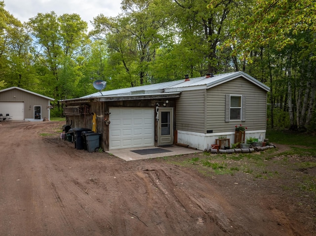 view of front of property with an outdoor structure and a garage