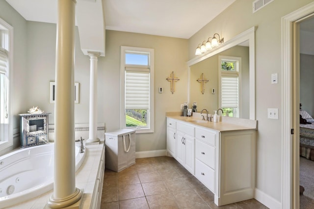 bathroom featuring tile patterned flooring, a relaxing tiled tub, and a healthy amount of sunlight