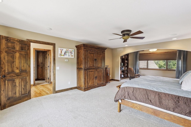 bedroom featuring ceiling fan and light carpet