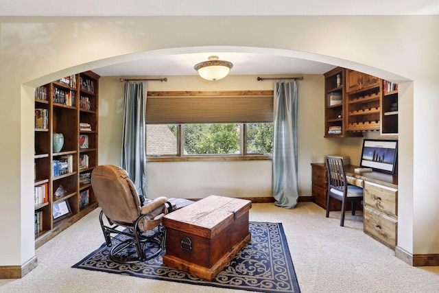 office area featuring light colored carpet and built in desk