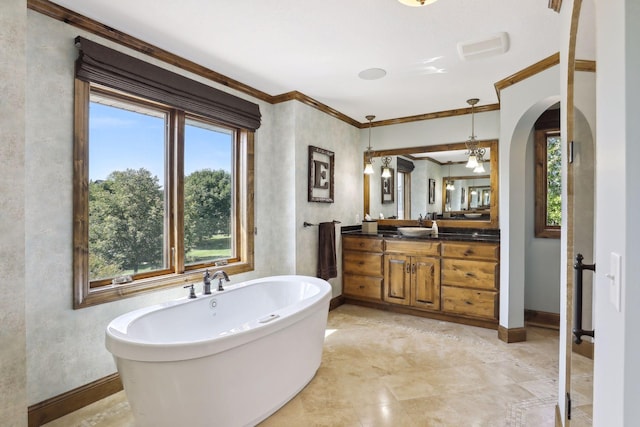 bathroom with a bathing tub, crown molding, and vanity