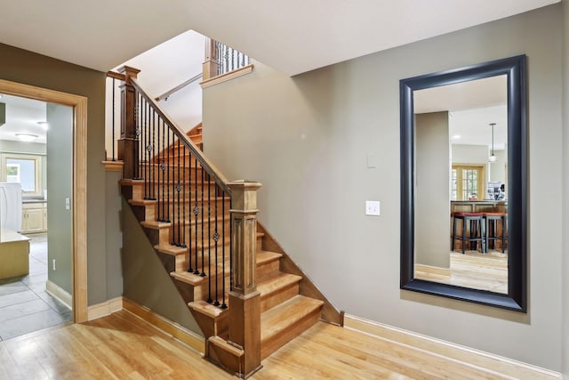 staircase with hardwood / wood-style floors