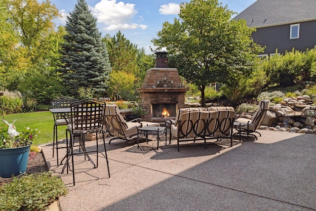 view of patio with an outdoor living space with a fireplace