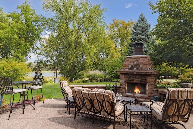 view of patio featuring an outdoor living space with a fireplace