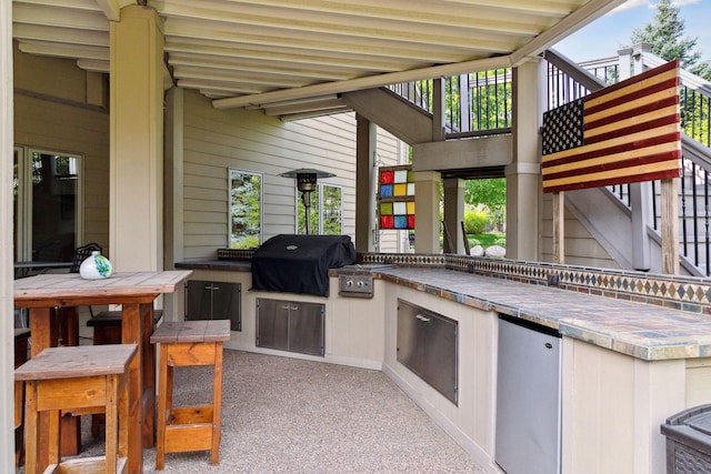 view of patio / terrace with a grill and an outdoor kitchen