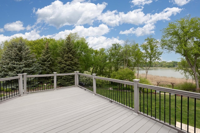 wooden terrace featuring a lawn and a water view