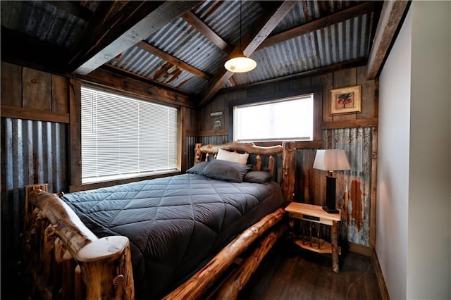 bedroom with wood walls, lofted ceiling with beams, and hardwood / wood-style flooring