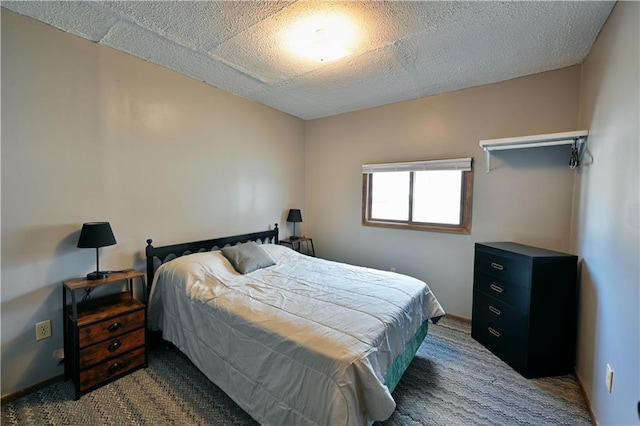 bedroom featuring carpet and a textured ceiling