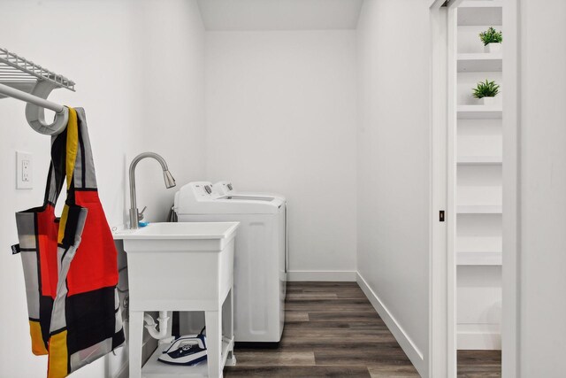 laundry area featuring washing machine and dryer and dark wood-type flooring