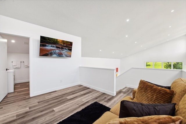 sitting room with vaulted ceiling and light hardwood / wood-style flooring