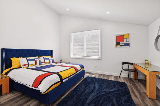 bedroom featuring dark hardwood / wood-style flooring and vaulted ceiling